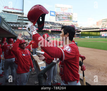 Shohei Ohtani (C) celebrates his third-inning home run with Los Angeles  Angels teammate Brett Phillips (L), holding a samurai warrior helmet,  during a baseball game against the Toronto Blue Jays at Angel