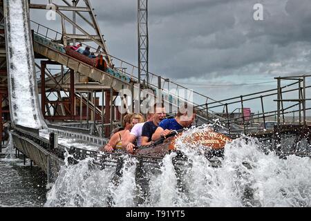 Les jeunes hommes à cheval le log flume de Great Yarmouth Pleasure Beach, Norfolk, UK Banque D'Images