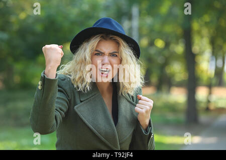 Angry young woman outdoors Banque D'Images