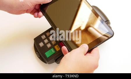 Payer avec une tablette sans fil sur la borne de carte de crédit. Banque D'Images