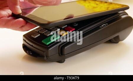 Payer avec une tablette sans fil sur la borne de carte de crédit. Banque D'Images