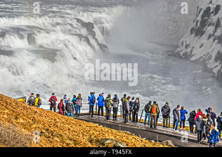 L'Islande, Gullfoss, Février 27, 2019 : quelques dizaines de touristes en regardant la célèbre cascade à partir d'une plate-forme derrière une clôture Banque D'Images