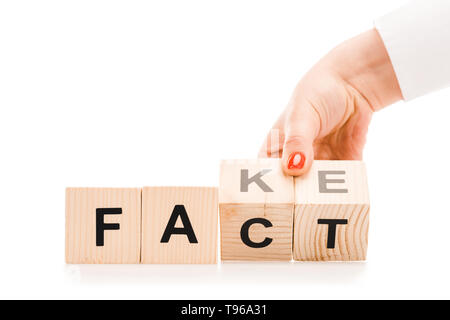 Vue partielle de woman holding blocs en bois avec fait ou faux mots isolated on white Banque D'Images