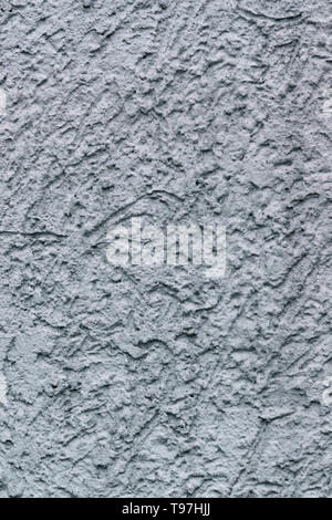 La texture de fond de lumière, de déco, mur de béton texturé présentant des irrégularités et des fissures Banque D'Images