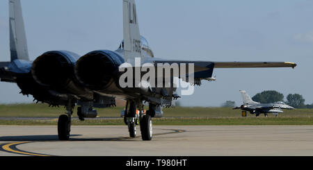 Un F-15E Strike Eagle affecté à la 492e Escadron de chasse des taxis, tandis qu'un F-16C Fighting Falcon affecté à la 93e Escadron de chasse, Homestead Air Reserve Base, en Floride, à Royal Air Force Lakenheath, Angleterre, le 16 mai 2019. La 93e déploiement FS à RAF Lakenheath démontre la capacité de la Force aérienne américaine à intégrer une équipe de la force totale dans les Forces aériennes américaines en Europe-Air Afrique formation et les opérations des Forces canadiennes. (U.S. Air Force photo par un membre de la 1re classe Madeline Herzog) Banque D'Images