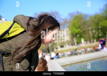 Portrait de petite fille à la recherche sur l'eau dans le parc Banque D'Images