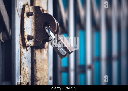 Laiton cadenas en acier avec verrouillage par clé sur porte métallique font de la chambre. Banque D'Images