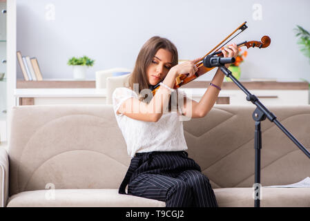 Belle femelle musicien à jouer du violon à la maison Banque D'Images