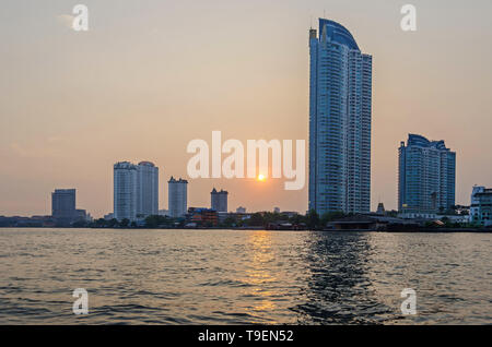 Bangkok, Thaïlande - 18 Avril 2018 : le coucher du soleil et l'horizon de la ville avec ses immeubles modernes, filigrane en copropriété rivière Chaophraya construire deux Banque D'Images