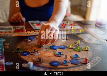 Balogunyom / Hongrie -04.28.2019 : femme joueur plaçant les pièces du jeu sur la carte tout en jouant à un jeu de stratégie terraformation de Mars Banque D'Images