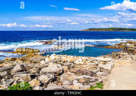 Les nageurs dans la piscine dans les rochers, au nord de Maroubra Beach à Sydney, Australie Banque D'Images