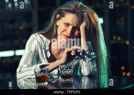 Jeune femme à boire l'alcool et le tabac cigare dans bar Banque D'Images