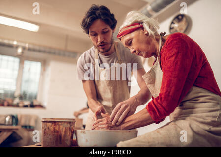 Belle homme agréable d'aider une femme âgée Banque D'Images