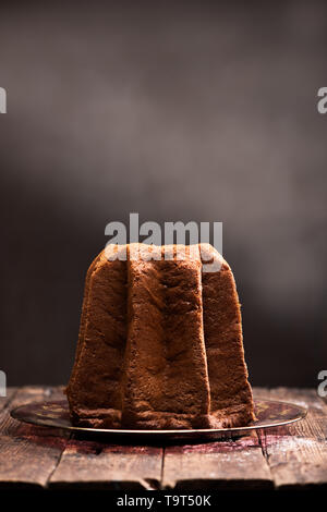 Avec Pandoro saupoudrage de sucre glace sur fond brun. Close up Banque D'Images