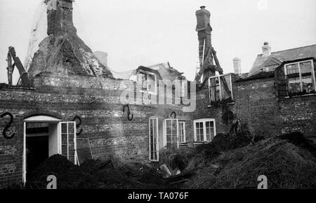 Produits de récupération à la suite d'un incendie de chaume c1973 dans la région de Weymouth, Dorset. Remarque Le bâtiment fumaient encore que les pompiers s'il reste en sécurité. Photo par Tony Henshaw Banque D'Images