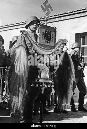 Photo d'un membre de l'orchestre militaire de la légion Condor tenant un croissant turc (décorée d'une croix gammée et l'emblème national espagnol) pendant le défilé à l'occasion de la célébration du jour de la Luftwaffe sur l'aéroport de Saragosse, Aragon le 1 mars 1939. Banque D'Images