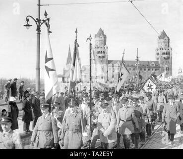 Avec des drapeaux et bannières avec la croix de Malte sur eux, les membres de plusieurs associations nationales de mars bienvenue Le président du Reich Paul von Hindenburg. Le Président du Reich était venu à Cologne à la libération de cérémonies tenues à l'occasion de l'évacuation des forces alliées de la Rhénanie. Sur la gauche en arrière-plan la cathédrale de Cologne. Banque D'Images