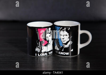 Deux tasses à espresso de marque Star Wars. Avec une Princesse Leia disant je t'aime et l'autre avec Han Solo dire je sais. Sur le banc en bois haut. Banque D'Images