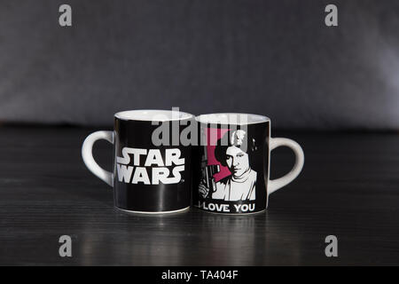 Deux tasses à espresso de marque Star Wars. Avec une Princesse Leia disant je t'aime et l'autre avec Han Solo dire je sais. Sur le banc en bois haut. Banque D'Images