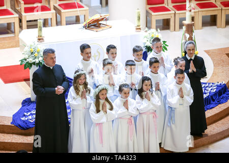 Zagreb, Croatie - Mai 5, 2019 : un groupe de jeunes filles et garçons vêtus de robes blanches avec prêtre et nun posant pour photographier à leur premier c Banque D'Images