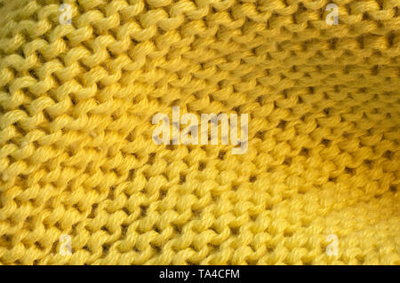 Contexte artistique à partir de tissu de laine tricoté jaune avec grandes boucles macro photographie Banque D'Images