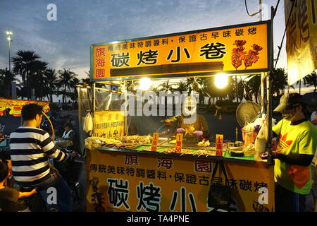 KAOHSIUNG, TAIWAN -- 22 DÉCEMBRE 2018 : Un vendeur de rue cuisiniers Calmar grillé près de la plage sur l'île de Cijin. Banque D'Images