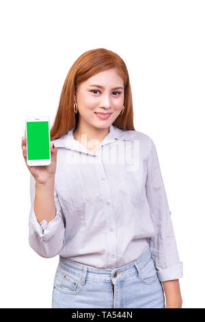 Smiling Asian woman holding mobile smartphone avec écran vert vierge debout sur fond blanc , clipping path : Banque D'Images