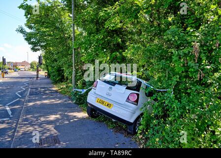 Une berline blanche face vers le bas dans un fossé après avoir perdu sur une route principale, Shepperton Surrey England UK Banque D'Images