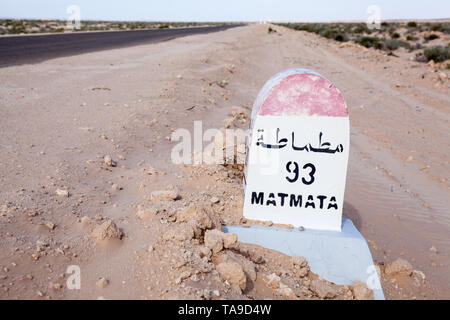 Milepost sur une route asphaltée à destination Matmata, Tunisie, Afrique. En passant par le lac salé chott El Djerid. Copy space Banque D'Images