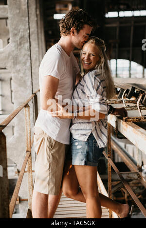 Happy young couple hugging dans une ancienne gare Banque D'Images