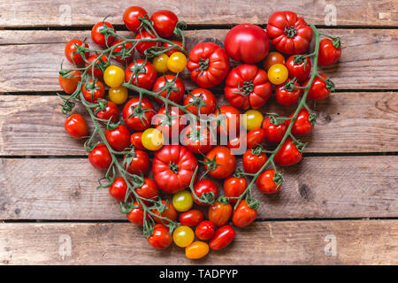 Diverses sortes de tomates coeur de construction sur bois Banque D'Images