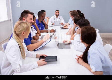 De jeunes spécialistes positif avec stéthoscope avoir Discussion des travaux de recherche dans la salle de conférence Banque D'Images