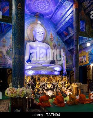 Moines en face de la statue de Bouddha de Wat Rong Seur dix, Temple Bleu, Chiang Rai, Thaïlande du Nord, Thaïlande Banque D'Images