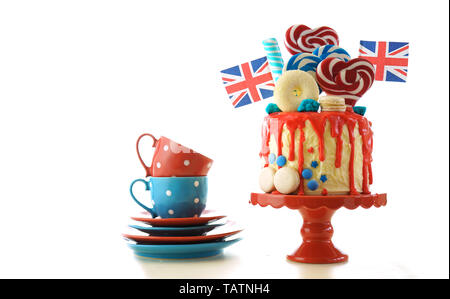 Royaume-uni le goutte-à-tendance candyland fantasy gâteau avec rouge, blanc et bleu décorations, sucettes et les drapeaux sur fond blanc. Banque D'Images