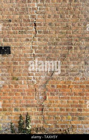 Fissures dans un vieux mur de brique rouge en raison de la subsidence Banque D'Images