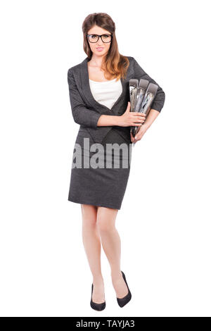 Businesswoman en tailleur holding folders Banque D'Images