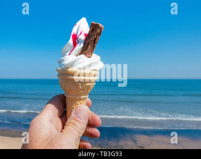 Quatre-vingt-dix neuf cornet de crème glacée à la framboise contre blues ciel et mer. UK Banque D'Images