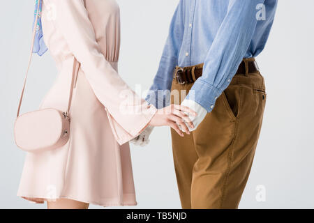 Portrait of Girl holding hands with mannequin isolé sur gray Banque D'Images