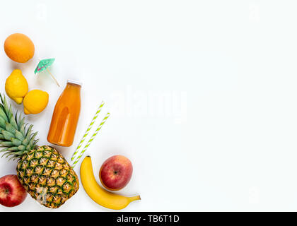 Vue de dessus de divers fruits, une bouteille de jus fraîchement pressés et de multivitamines cocktail accessoires sur un fond blanc. Copier l'espace. Mise à plat. Banque D'Images