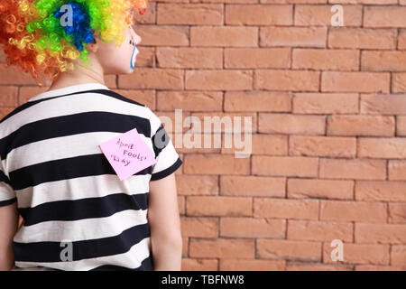 Post-it avec des mots "poisson d'avril' sur dos de l'enfant Banque D'Images