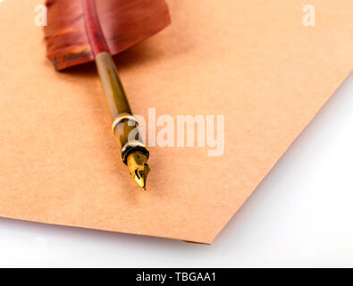 Old vintage brûlées lettre enveloppe avec quill stylo plume isolé sur fond blanc Banque D'Images