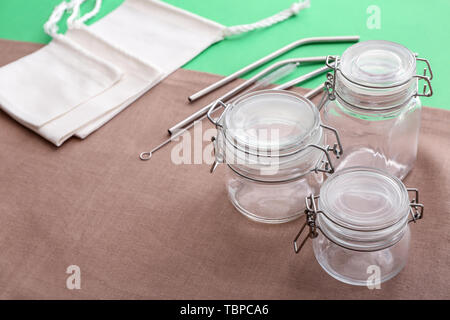 Bocaux en verre, sacs en tissu et métal sur un fond de couleur paille. Concept Zéro déchet Banque D'Images