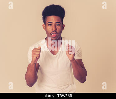 Portrait of young african american man sentiment effrayé et choqué. Adolescent dégoûté par ce qui se passe sur son visage. Dans l'horreur et Banque D'Images