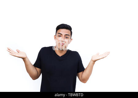 Beau jeune homme est confus et surprise avec deux mains geste de côté. Place pour le texte. Banque D'Images
