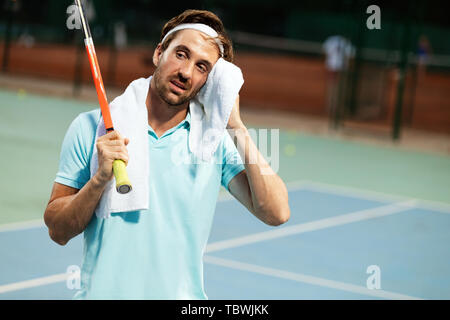 Joueur de tennis homme fatigué sur raquette de tennis avec Banque D'Images
