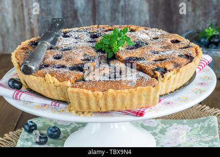 Tarte aux bleuets et amandes saupoudrés de sucre glace Banque D'Images