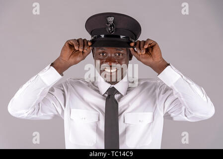 England UK. Mai 2019. Portrait of a modifié son chauffeur uniforme noir hat. Banque D'Images