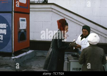 Les touristes de l'Ouest l'achat de nourriture à un vendeur de rue à Moscou, Russie, 1973. () Banque D'Images