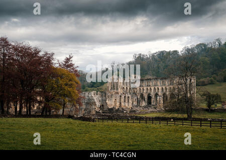 Des nuages sombres sur le 11e siècle, ruines de l'abbaye de Rievaulx, l'un des plus importants monastères cisterciens, dans le North York Moors Banque D'Images