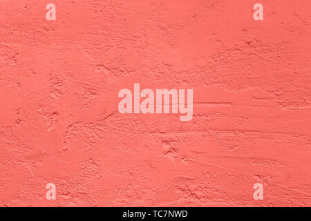 Le béton de couleur corail très tendance avec fond texturé et irrégularités de rugosité de votre concept ou produit. Banque D'Images